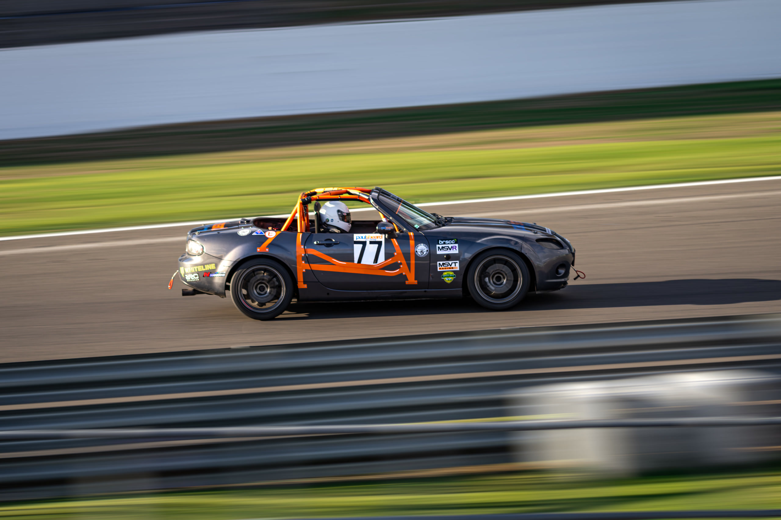 Christian Valverde's Mazda MX-5 Mk3, number 77, at speed at Silverstone