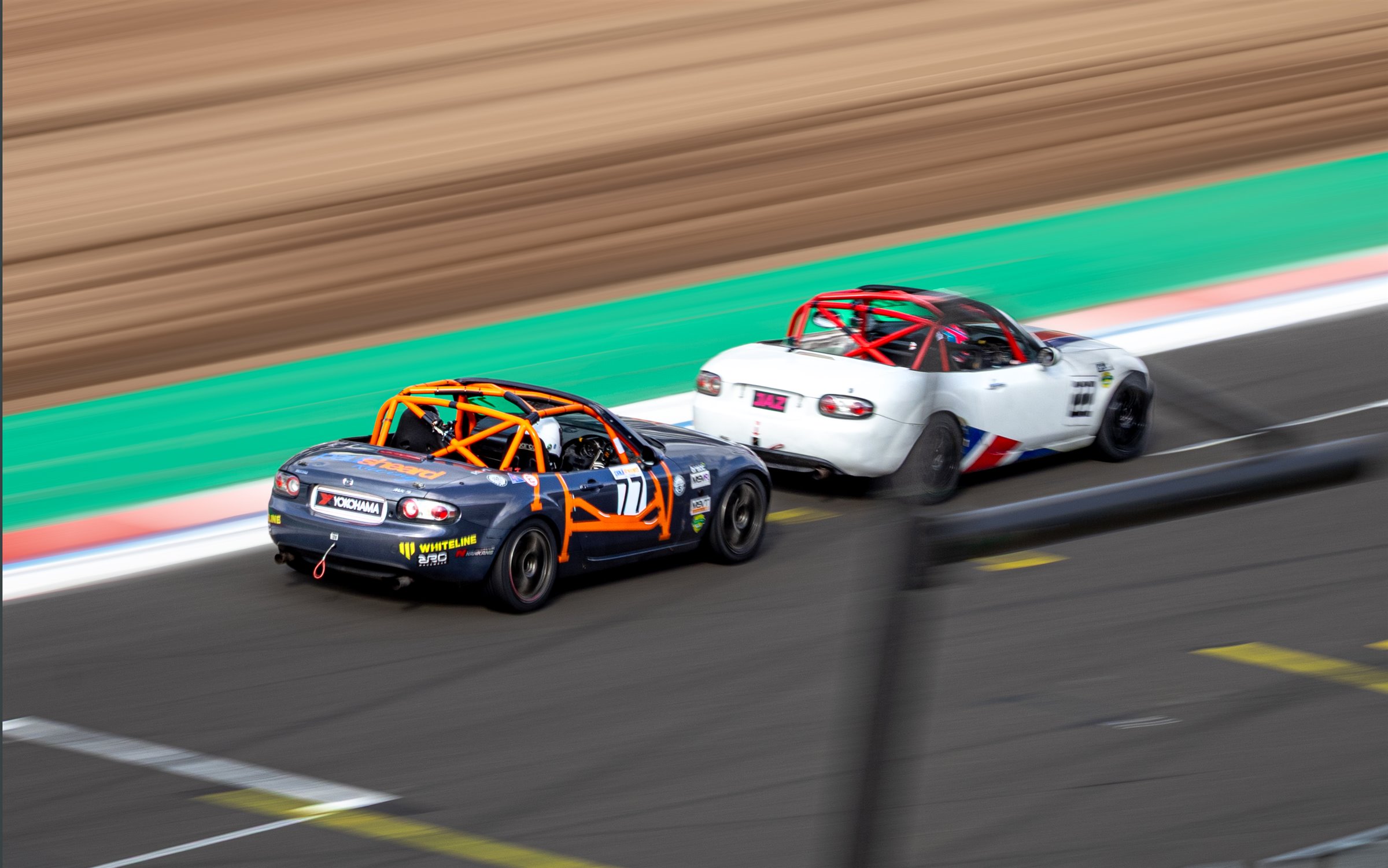 Two MX-5s leaving the pit lane at Silverstone