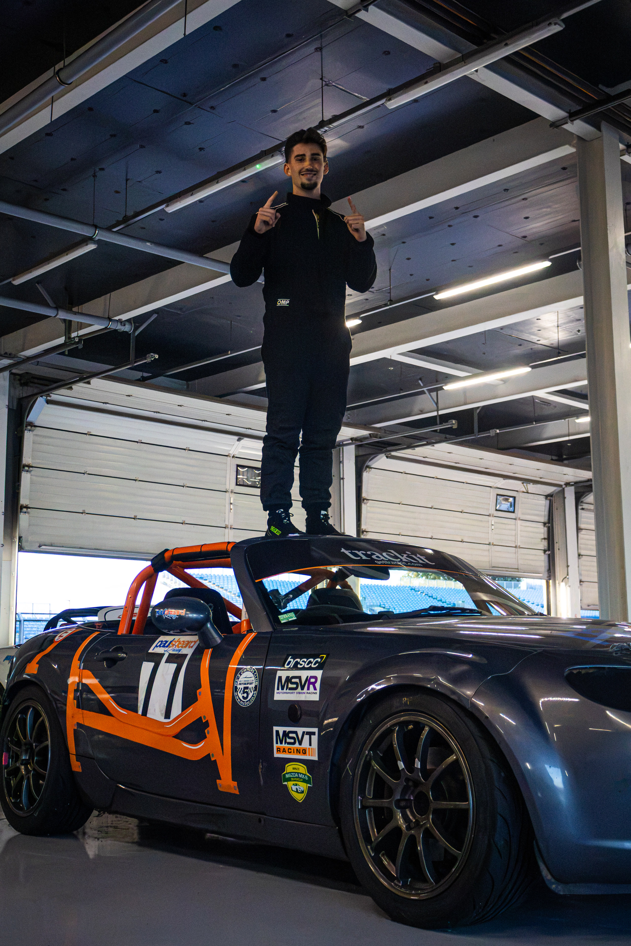 Christian Valverde standing on the MX-5 in the garage