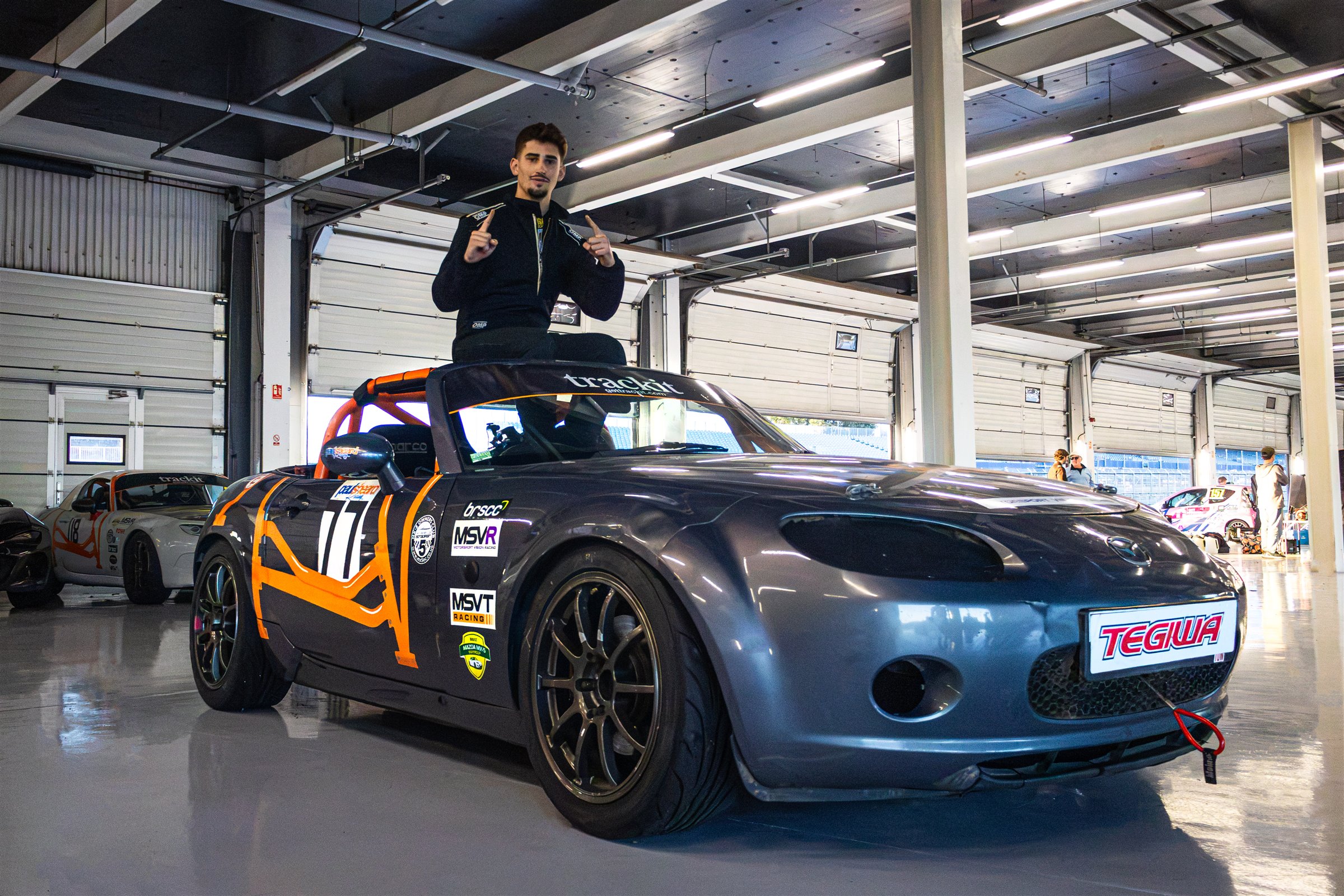 Christian Valverde standing on the MX-5 in the garage