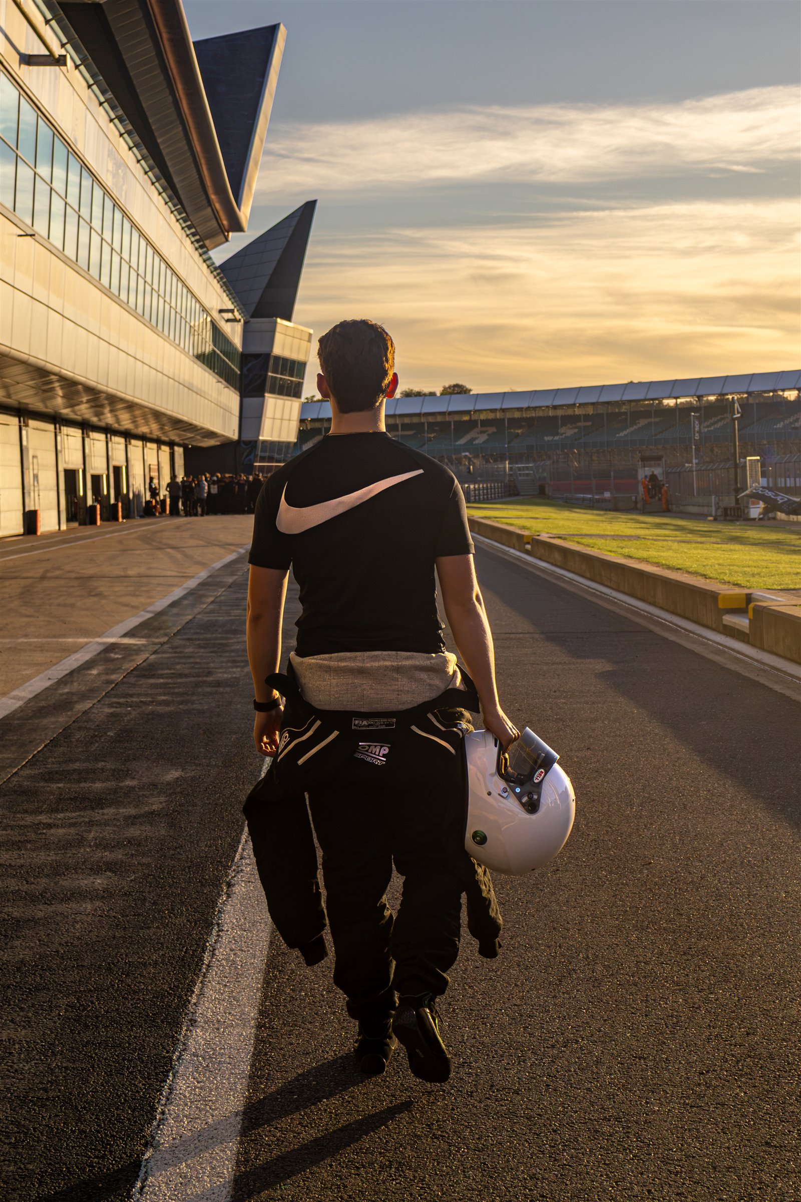 Christian Valverde walking down the pit lane with his helmet